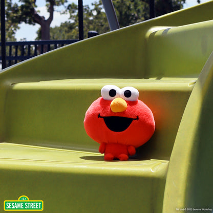 Cloudheads: 5" Elmo sitting on a set of yellow playground stairs
