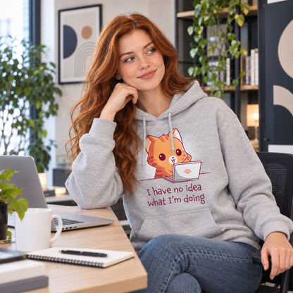 Pullover Hoodie_TeeTurtle light gray I Have No Idea What I'm Doing (Cat) Pullover Hoodie featuring a cheerful orange tabby cat sitting behind a laptop with one paw raised and the text "I have no idea what I'm doing."