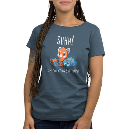 A woman wearing a denim blue Shhh! I'm Counting Stitches! t-shirt from TeeTurtle.