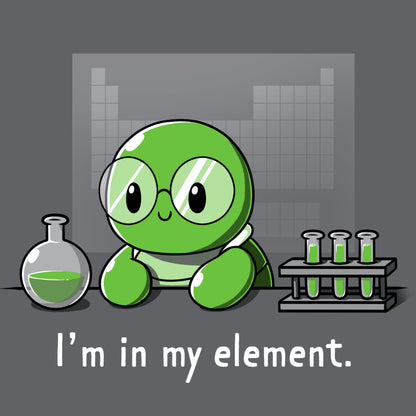 A cartoon green turtle wearing glasses is in a lab with beakers and test tubes filled with green liquid. Text below reads, "I'm in my element." Wear this scene on an "I'm in My Element" t-shirt made from charcoal gray Super Soft Ringspun Cotton by monsterdigital.
