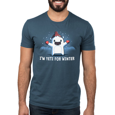 Premium Cotton T-shirt_Teeturtle denim  blue I'm Yeti for Winter apparel featuring a happy Yeti in the snowy winter mountains wearing a pom-pom winter hat and mittens. Caption reads "I'm yeti for winter".