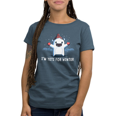 Premium Cotton T-shirt_Teeturtle denim  blue I'm Yeti for Winter apparel featuring a happy Yeti in the snowy winter mountains wearing a pom-pom winter hat and mittens. Caption reads "I'm yeti for winter".