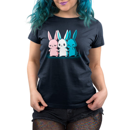 Person wearing a navy blue t-shirt made from super soft ringspun cotton, featuring monsterdigital's Inclusive Bunnies in pink, white, and blue standing in a row.