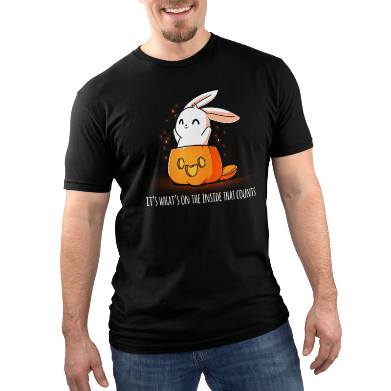 A cute AND spooky "What's on the Inside (Glow)" black t-shirt featuring a rabbit sitting on a pumpkin by TeeTurtle.