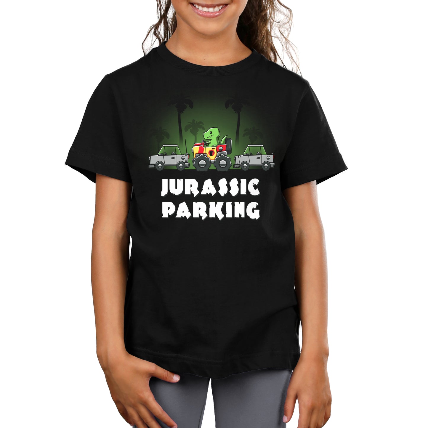 A girl wearing a black t-shirt that says TeeTurtle Jurassic Parking.