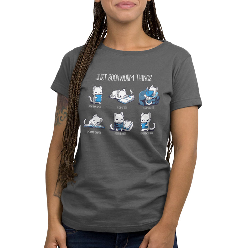 Person wearing a charcoal gray "Just Bookworm Things" tee by monsterdigital, with illustrations of cats and the text "Just Bookworm Things." The images depict cats engaged in various reading-related activities, all on a super soft ringspun cotton fabric.