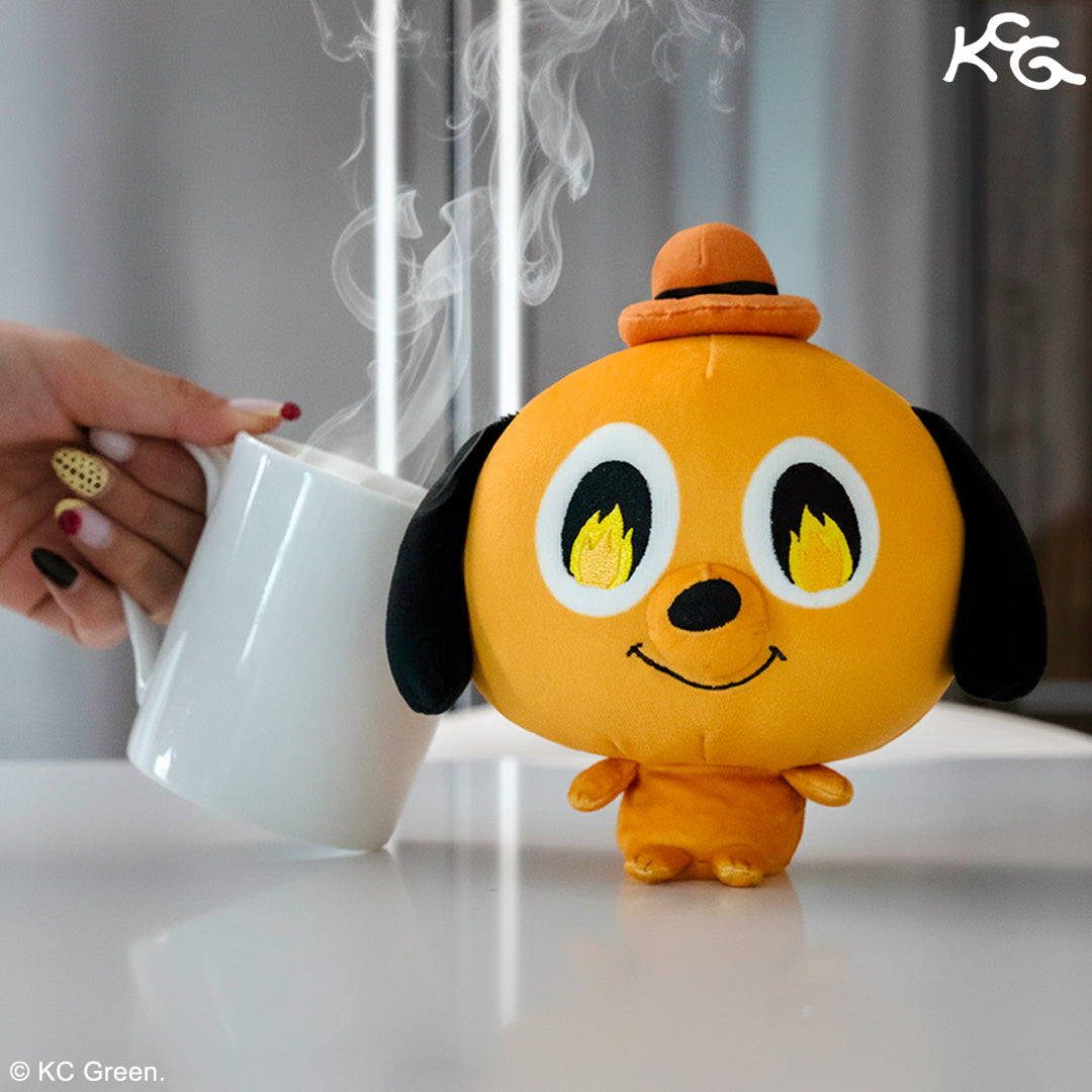 Cloudheads: 5" Question Hound sitting on a desk with a hand holding a steaming coffee cup against it