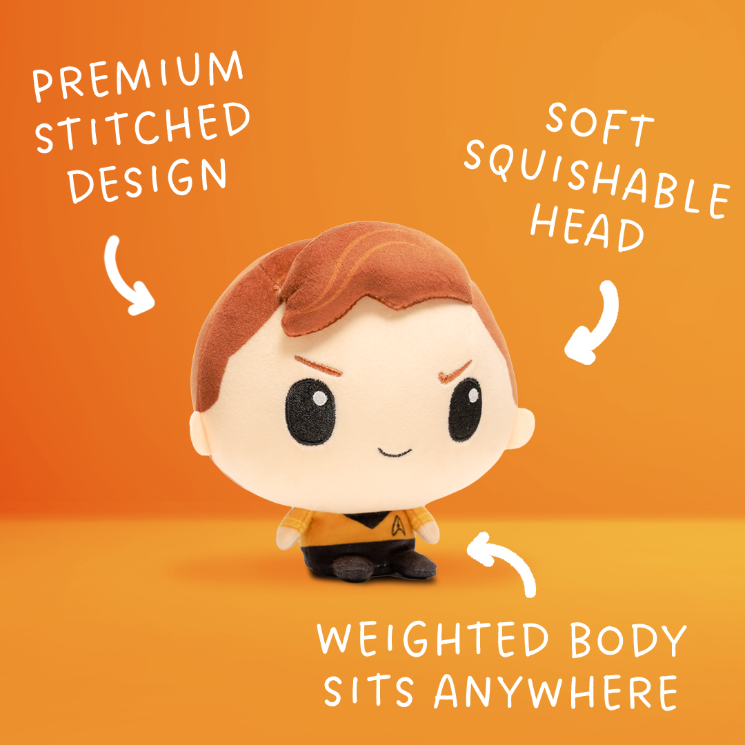 Front view of a Captain Kirk plush with reddish-brown hair, a gold Starfleet uniform, black collar, and Starfleet insignia.