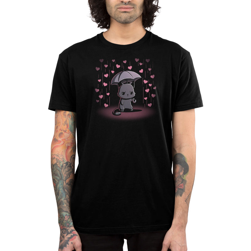 Premium Cotton T-shirt_TeeTurtle black Feeling Forecast Nope Premium Cotton T-shirt featuring a cat frowning and holding an umbrella, in the background there is pink rain with hearts.