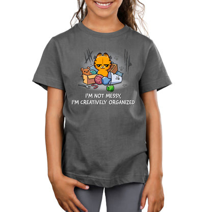 Premium Cotton T-shirt_TeeTurtle charcoal gray I'm Not Messy, I'm Creatively Organized apparel featuring a smug Garfield surrounded by a messy assortment of objects.