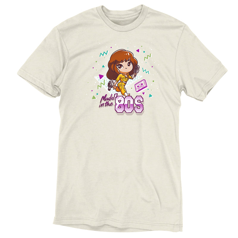 Premium Cotton T-shirt_TeeTurtle natural heather Made in the 80s apparel featuring April O'Neil from Teenage Mutant Ninja Turtles holding a camcorder and microphone with 90's elements in the background, such as a cassette tape, and the caption, "Made in the 80s".