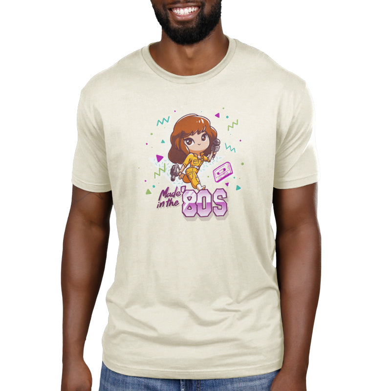 Premium Cotton T-shirt_TeeTurtle natural heather Made in the 80s apparel featuring April O'Neil from Teenage Mutant Ninja Turtles holding a camcorder and microphone with 90's elements in the background, such as a cassette tape, and the caption, "Made in the 80s".