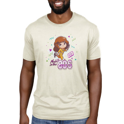 Premium Cotton T-shirt_TeeTurtle natural heather Made in the 80s apparel featuring April O'Neil from Teenage Mutant Ninja Turtles holding a camcorder and microphone with 90's elements in the background, such as a cassette tape, and the caption, "Made in the 80s".