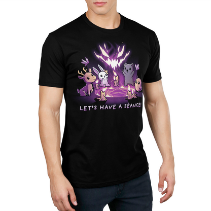 Premium Cotton T-shirt_TeeTurtle Let's Have a Séance! black t-shirt featuring an illustration of a deer, bunny, cat and owl having a séance on a pentagram surrounded by burning candles with "LET'S HAVE A SEANCE!" written underneath. A large, stylized, glowing, purple and white face hovers above the animals created by the flames.