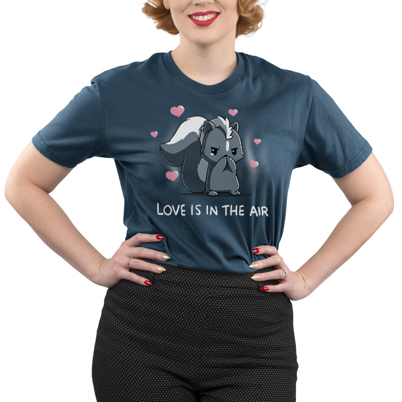 Premium Cotton T-Shirt_TeeTurtle denim blue Scentimental Feelings Premium Cotton T-Shirt featuring a skunk standing up on its back legs with its front paws covering its nose, hearts coming out in the background with the caption, "love is in the air".
