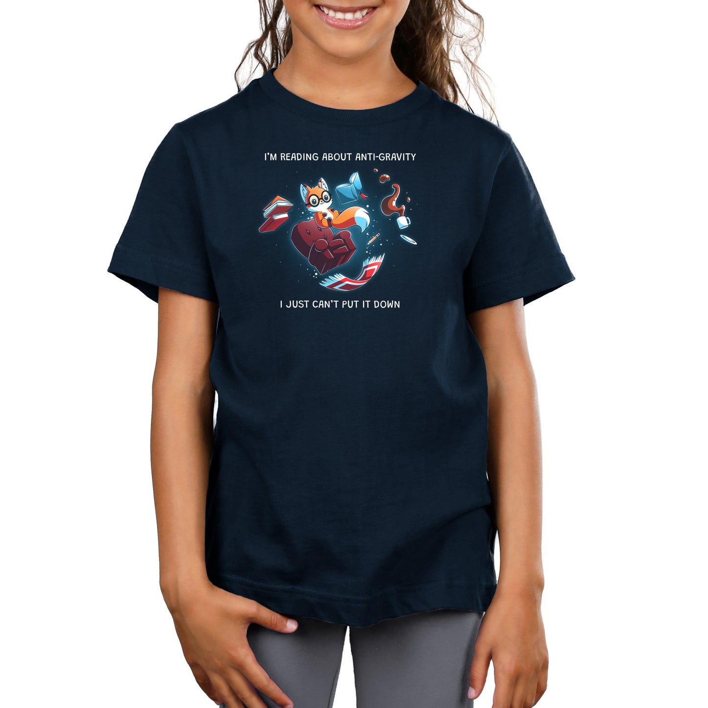 Premium Cotton T-shirt_TeeTurtle navy blue Anti-Gravity Enthusiast apparel featuring a fox wearing glasses reading a book with floating in mid-air with its living room furniture, such as a chair, rug, and lamp, with the caption, “I’m Reading About Anti-Gravity, I Just Can’t Put It Down“.
