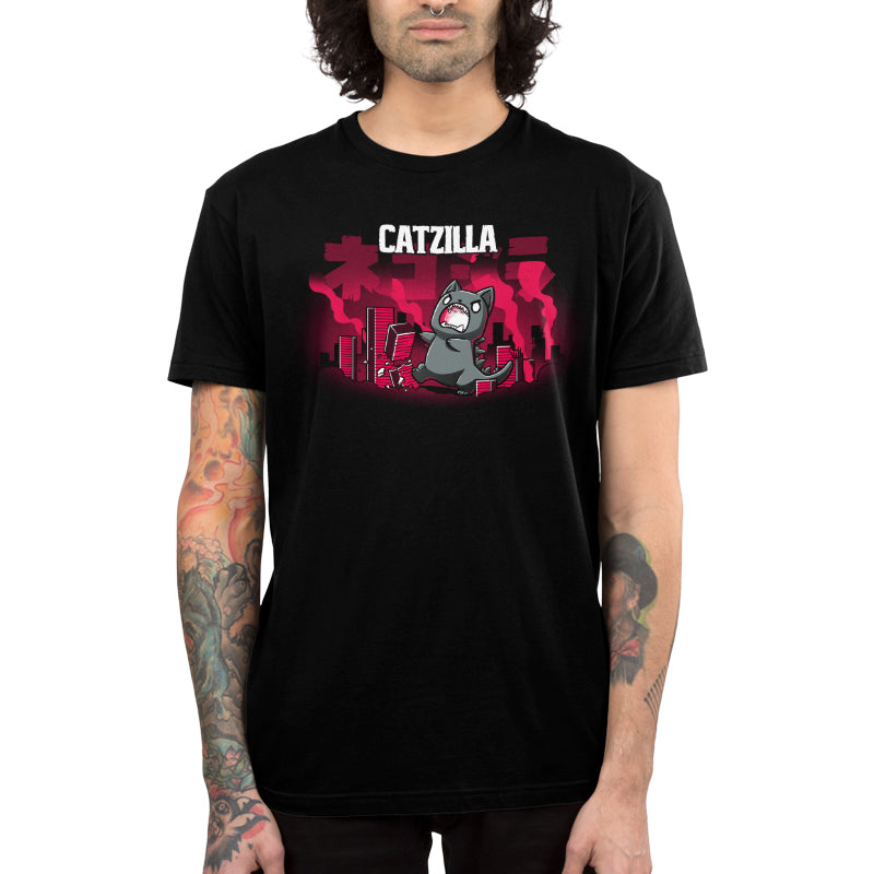 Premium Cotton T-shirt_TeeTurtle Catzilla black t-shirt featuring an illustration of an angry gray cat terrorizing a city knocking down red, blocky buildings with reddish-pink smoke filling the air and "Catzilla" written above the graphic. The text beneath the word CATZILLA resembles Japanese characters or simplified Chinese characters.