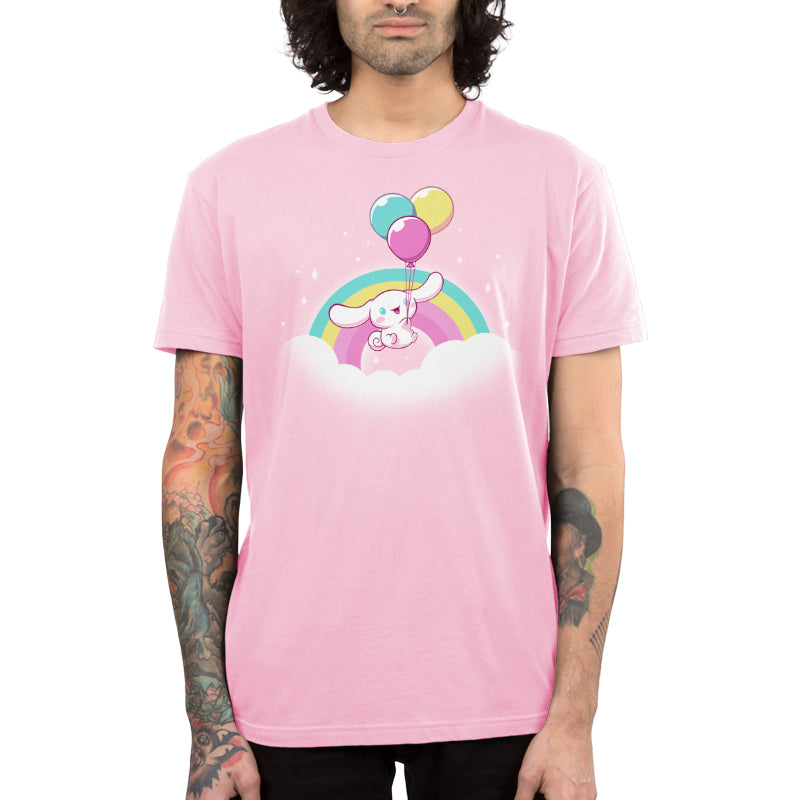 Premium Cotton T-shirt_TeeTurtle light pink Cinnamoroll Takes Flight apparel featuring Cinnamoroll floating in the clouds with a teal, yellow, and pink rainbow in the background, and holding onto balloons in the same colors as the rainbow.