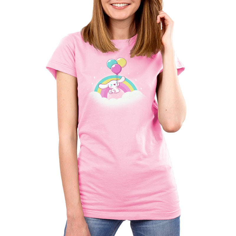 Premium Cotton T-shirt_TeeTurtle light pink Cinnamoroll Takes Flight apparel featuring Cinnamoroll floating in the clouds with a teal, yellow, and pink rainbow in the background, and holding onto balloons in the same colors as the rainbow.