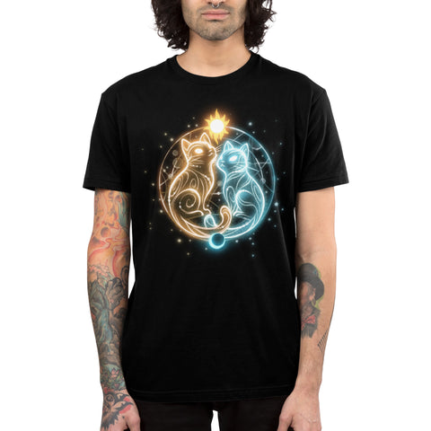 Premium Cotton T-shirt_TeeTurtle black Cosmic Whiskers apparel featuring a golden cat with celestial swirls and a white cat with celestial swirls facing each other with a celestial circle behind them, the sun on top, and the moon below.