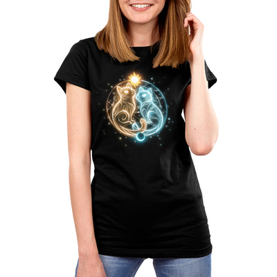 Premium Cotton T-shirt_TeeTurtle black Cosmic Whiskers apparel featuring a golden cat with celestial swirls and a white cat with celestial swirls facing each other with a celestial circle behind them, the sun on top, and the moon below.