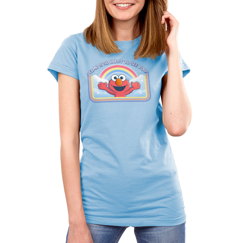 Premium Cotton T-shirt_TeeTurtle light blue Elmo Is So Happy To See You Premium Cotton T-shirt featuring Elmo from Sesame Street. He's smiling and has his arms wide as if he's going in for a hug. There's a rainbow and clouds behind him and  there is a retro style border along the sides and bottom. At the top is the text "Elmo Is So Happy To See You." 