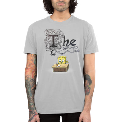Premium Cotton T-shirt_TeeTurtle silver gray SpongeBob's Essay apparel featuring SpongeBob sitting at a desk with a pencil writing his essay, with the word, “The” decorated with many flourishes on top.