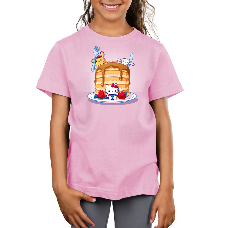 Premium Cotton T-shirt_TeeTurtle light pink Flapjacks and Friends apparel featuring Hello Kitty sitting in the middle of some strawberries and blueberries, Cinnamoroll holding a giant knife, and Pompompurin holding a giant fork with a giant stack of pancakes.