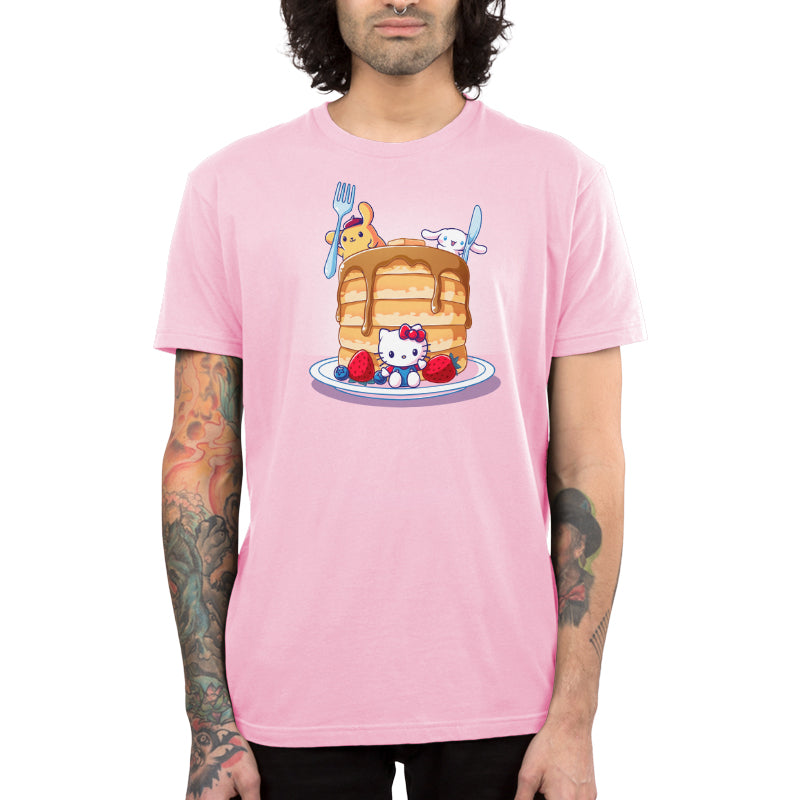 Premium Cotton T-shirt_TeeTurtle light pink Flapjacks and Friends apparel featuring Hello Kitty sitting in the middle of some strawberries and blueberries, Cinnamoroll holding a giant knife, and Pompompurin holding a giant fork with a giant stack of pancakes.