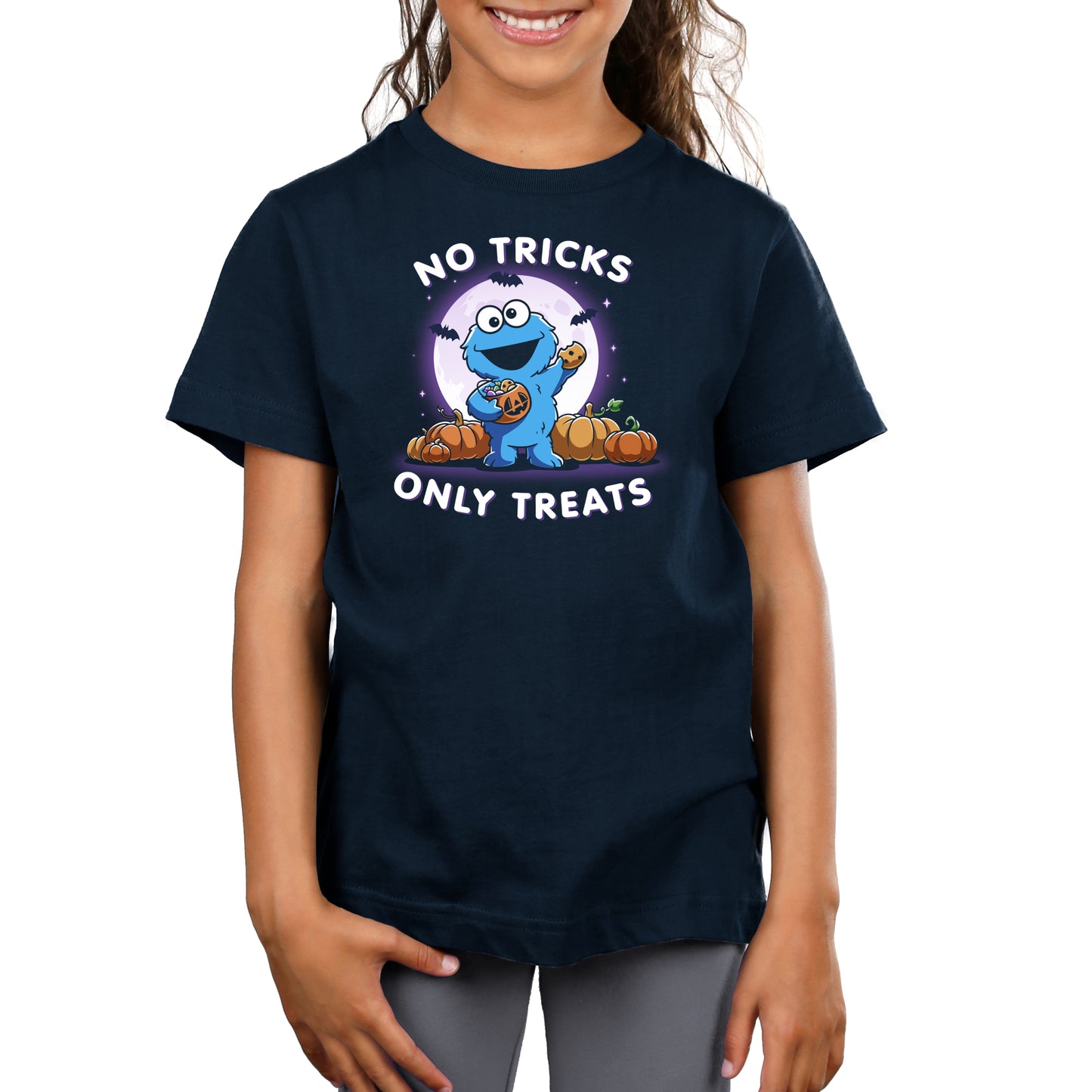 Premium Cotton T-shirt_TeeTurtle navy blue No Tricks Only Treats (Cookie Monster) apparel featuring Cookie Monster holding a cookie and a pumpkin basket of treats with pumpkins, bats, and a full moon in the background, and the caption, “No Tricks, Only Treats“.