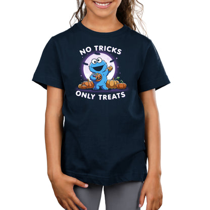 Premium Cotton T-shirt_TeeTurtle navy blue No Tricks Only Treats (Cookie Monster) apparel featuring Cookie Monster holding a cookie and a pumpkin basket of treats with pumpkins, bats, and a full moon in the background, and the caption, “No Tricks, Only Treats“.