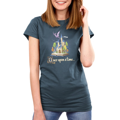 Premium Cotton T-shirt_TeeTurtle denim blue Once Upon a Time apparel featuring an open book with a castle and flying dragon emerging from it.