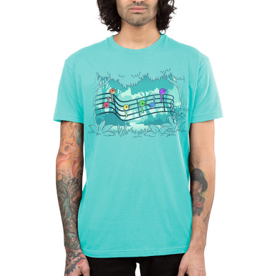 Premium Cotton T-shirt_TeeTurtle Caribbean blue Rainbow Song Birds apparel featuring song birds in various colors perched on a musical staff with a forest in the background.