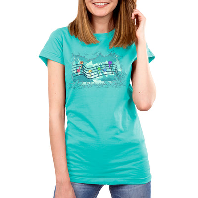 Premium Cotton T-shirt_TeeTurtle Caribbean blue Rainbow Song Birds apparel featuring song birds in various colors perched on a musical staff with a forest in the background.