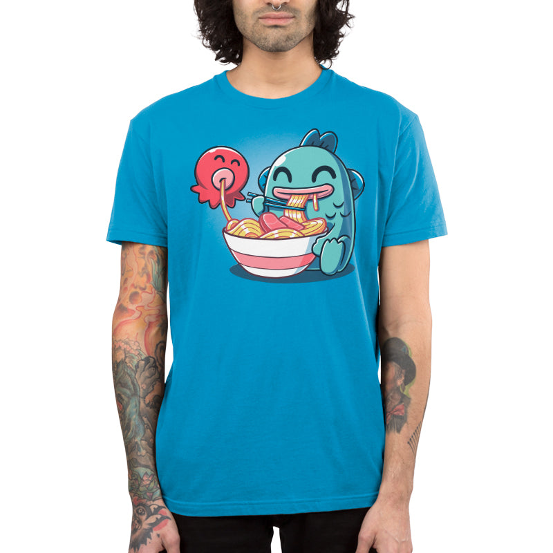 Premium Cotton T-shirt_TeeTurtle cobalt blue Ramen Hangyodon apparel featuring the Sanrio characters Hangyodon and Sayuri eating a large bowl of ramen.