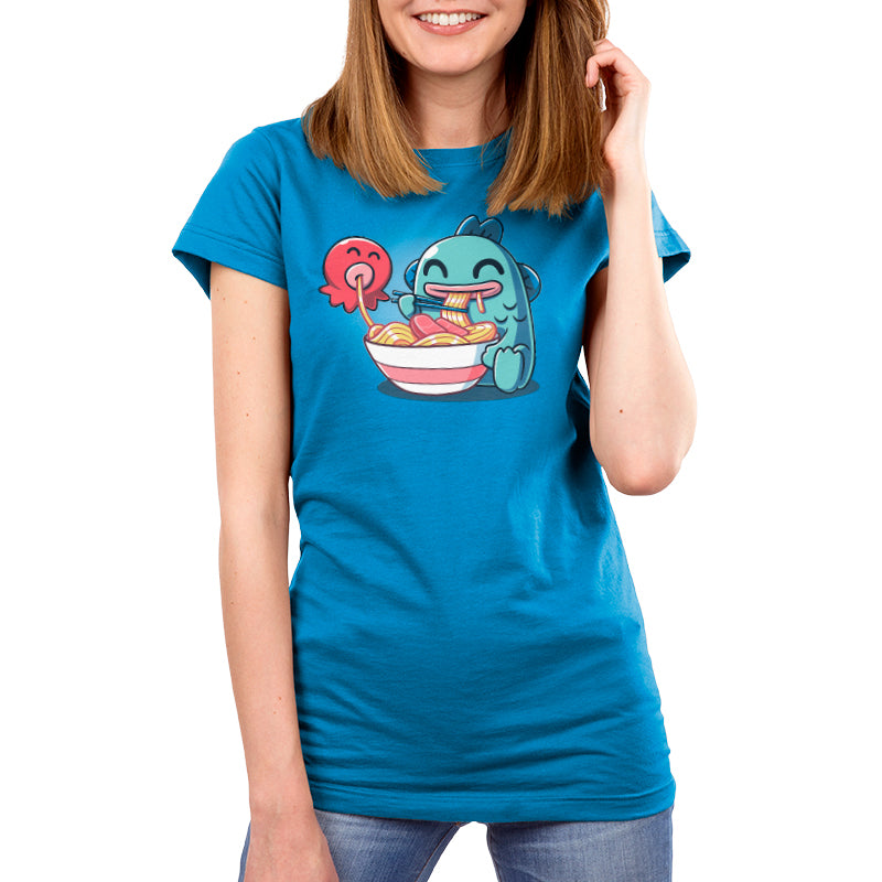 Premium Cotton T-shirt_TeeTurtle cobalt blue Ramen Hangyodon apparel featuring the Sanrio characters Hangyodon and Sayuri eating a large bowl of ramen.