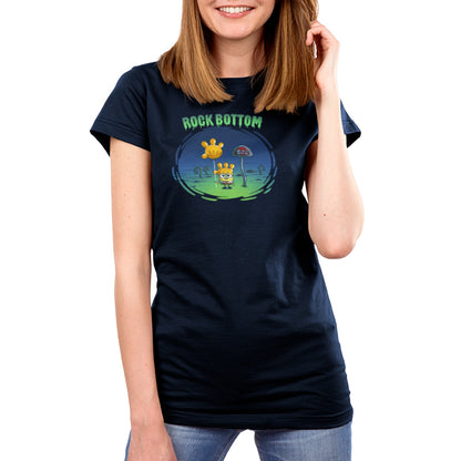 Premium Cotton T-shirt_TeeTurtle navy blue SpongeBob Rock Bottom apparel featuring SpongeBob Square Pants holding a yellow balloon that looks like a four fingered hand while wearing a second simliar balooon on his head as a hat. He looks sad and he's next to a "Buz" sign.The words "Rock Bottom" are on top in green and they look like they are melting or dripping. 