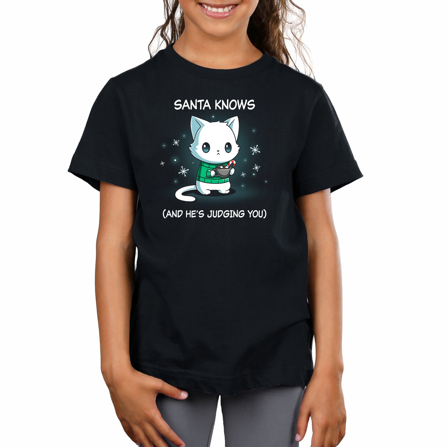Premium Cotton T-shirt_TeeTurtle black Santa Knows apparel featuring a cat with a deadpan expression holding mug with hot chocolate, marshmallows, and a candy cane surrounded by snowflakes, with the caption, “Santa Knows (And He’s Judging You)“.