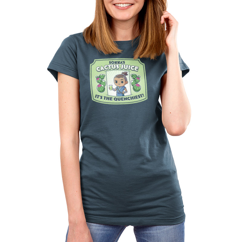Premium Cotton T-shirt_TeeTurtle denim blue Sokka's Cactus Juice featuring a label with a drawing of two cactuses, Sokka from Avatar: The Last Airbender holding a glass full of green liquid, and text that says "Sokka's Cactus Juice" at the top and "It's the quenchiest!" at the bottom. 