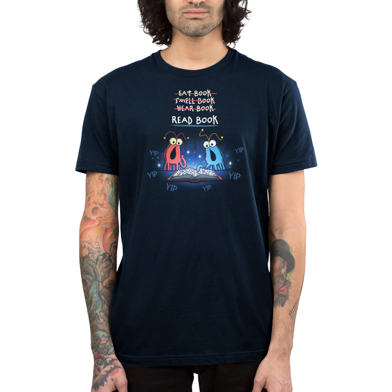 Premium Cotton T-shirt_TeeTurtle navy The Martians Read Book Premium Cotton T-shirt featuring the red and blue yip yip martians from Sesame Street in a classic moment where they are trying to figure out what to do with a book that is open in front of them. Text above them reads "Eat Book," "Smell Book," and "Hear Book" with all of them crossed out and "Read Book" underneath. They are surrounded by the word "yip." 