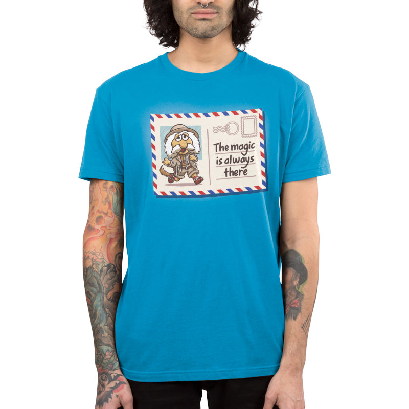 Premium Cotton T-shirt_TeeTurtle cobalt blue The Magic Is Always There apparel featuring Uncle Traveling Matt on a mail postcard with the caption on the underneath the stamp, “The Magic Is Always There“.