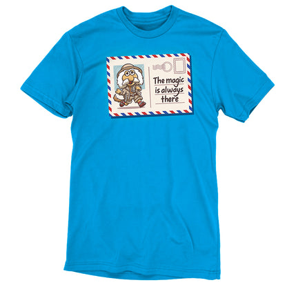 Premium Cotton T-shirt_TeeTurtle cobalt blue The Magic Is Always There apparel featuring Uncle Traveling Matt on a mail postcard with the caption on the underneath the stamp, “The Magic Is Always There“.