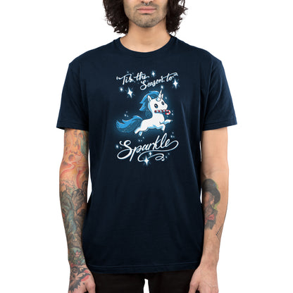 Premium Cotton T-shirt_TeeTurtle navy blue 'Tis The Season To Sparkle apparel featuring a leaping unicorn with a candy cane in its mouth surrounded by sparkles, with the caption, “'Tis The Season To Sparkle“.
