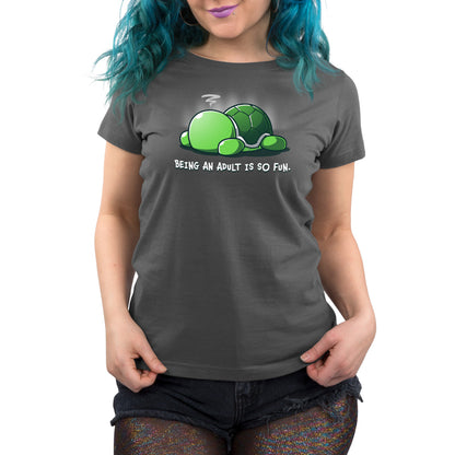 Premium Cotton T-shirt - Person wearing a charcoal gray apparelmade of super soft ringspun cotton, featuring a graphic of a green turtle and the text "Being An Adult Is So Fun" by monsterdigital, paired with black distressed shorts and sparkly tights.