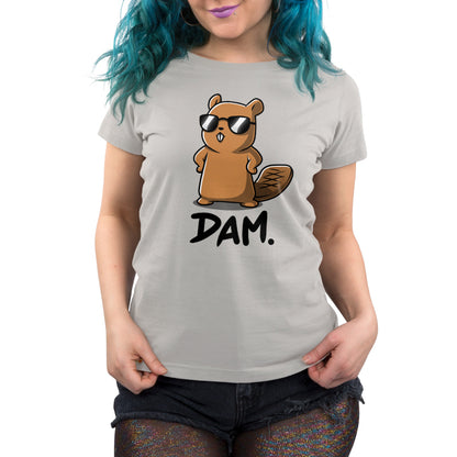 Premium Cotton T-shirt - Person with teal hair wearing a silver gray monsterdigital apparel made from super soft cotton, featuring a cartoon beaver wearing sunglasses and the text "Dam." They are also wearing black shorts.