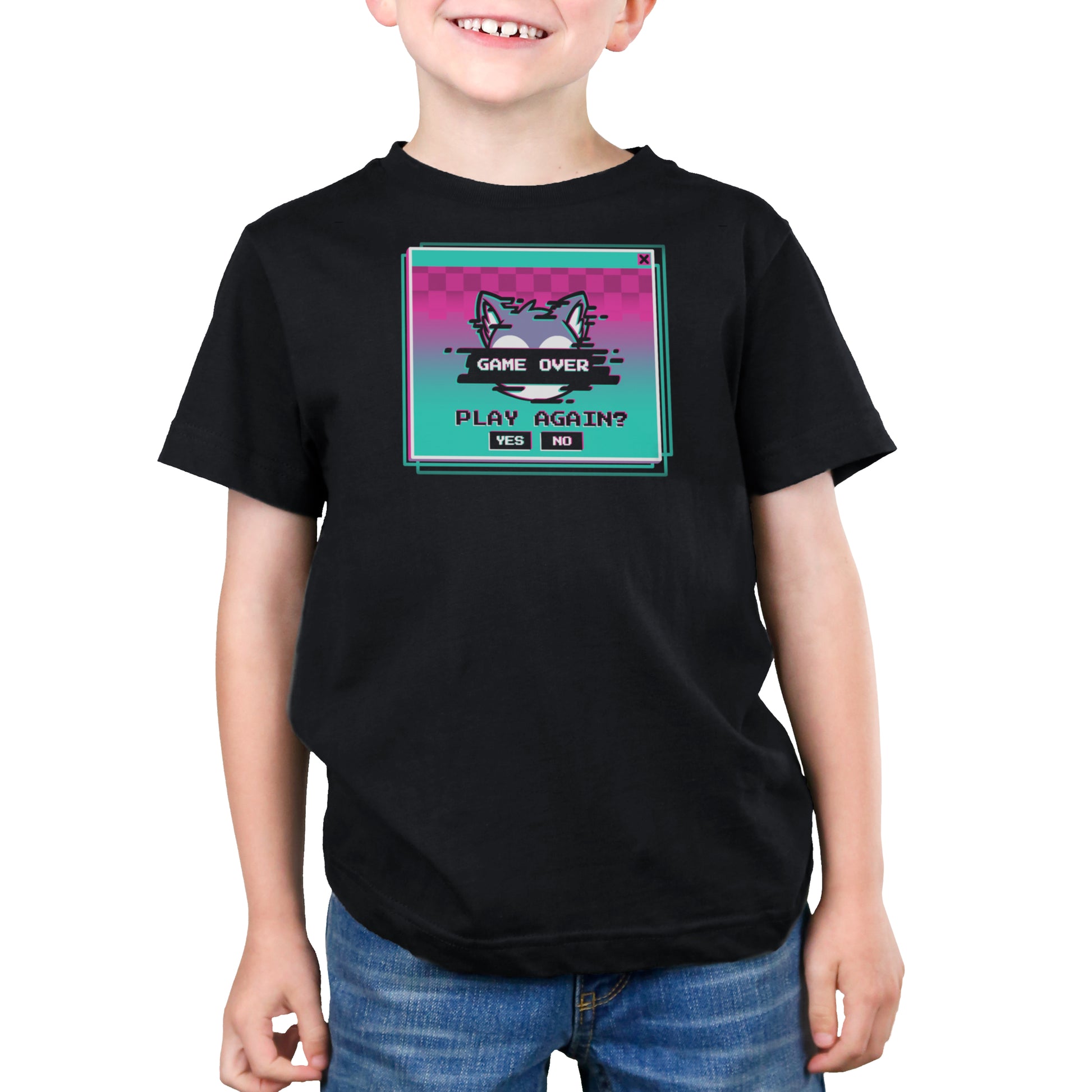 A child wearing a black Game Over, Play Again? t-shirt from monsterdigital made from super soft ringspun cotton with a colorful graphic of a cat and the text "Game Over" and "Play Again? Yes No." The unisex tee complements their slight smile as they stand with hands by their sides.
