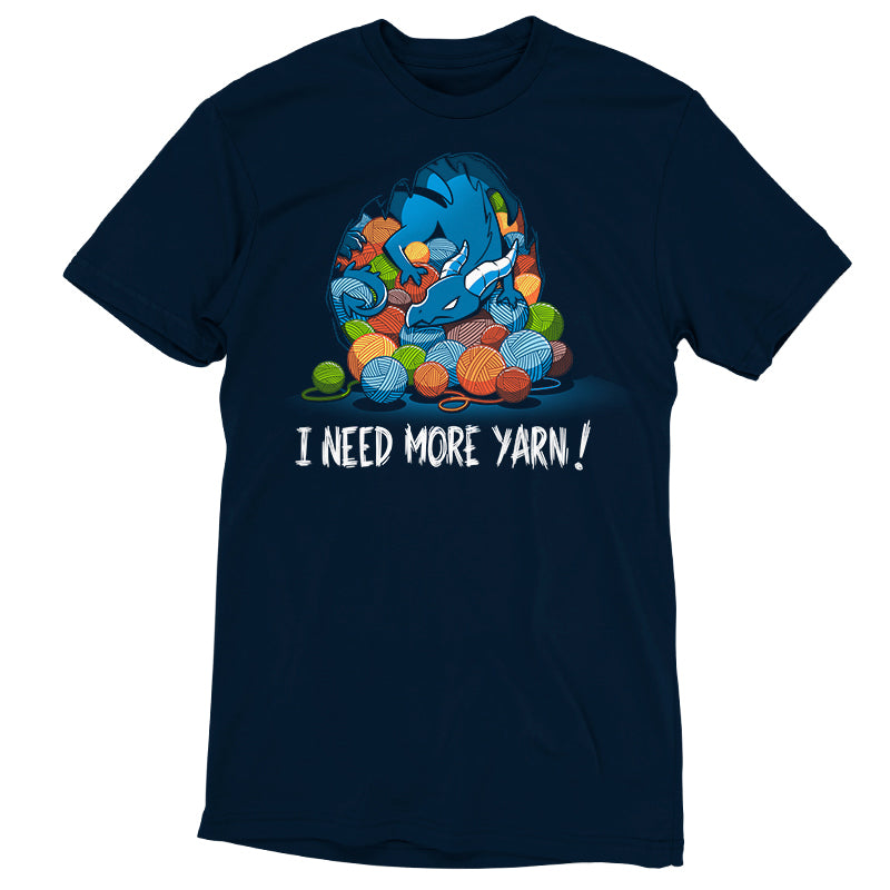 Premium Cotton T-shirt_TeeTurtle Yarn Hoarder navy blue t-shirt featuring a blue dragon sitting on top of a pile of multi-colored yarn balls. The words "I NEED MORE YARN!" are written underneath the illustration.