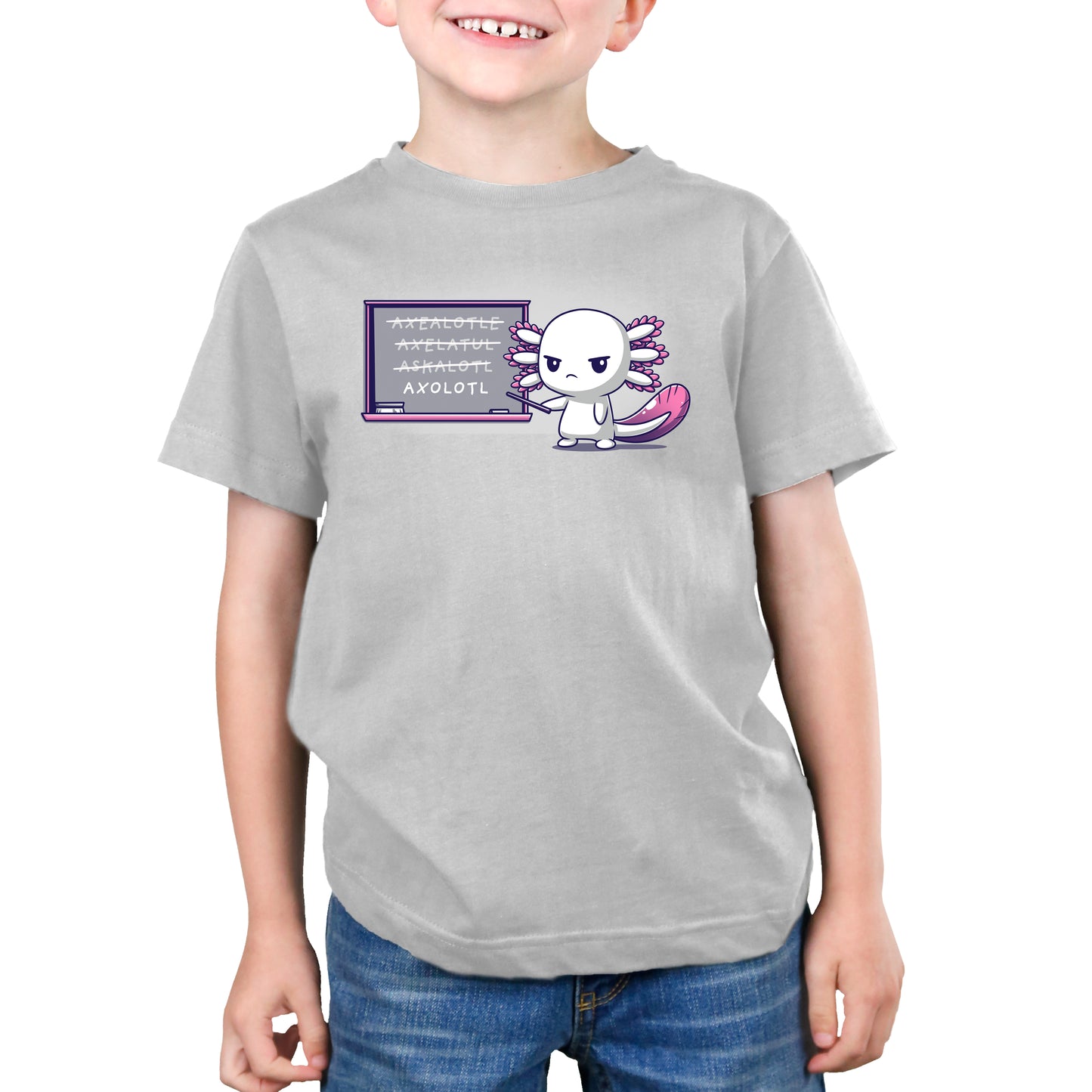 A child wearing a silver monsterdigital t-shirt made from super soft ringspun cotton with a cartoon axolotl character called Axolotl Lesson stands in front of a chalkboard with text on it. The child is smiling and has their hands at their sides.