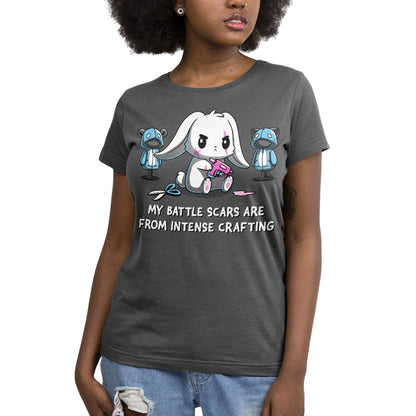 Premium Cotton T-shirt - Person wearing a monsterdigital Battle Scars apparel in charcoal gray, featuring a cartoon bunny with bandages, surrounded by crafting tools, and the text "My battle scars are from intense crafting.