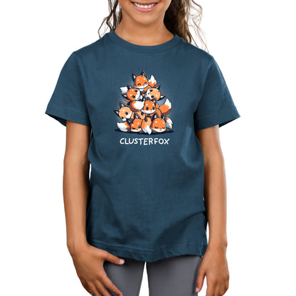 A child wearing a super soft ringspun cotton, denim blue Clusterfox t-shirt by monsterdigital with an illustration of a pyramid of foxes and the word "CLUSTERFOX" printed below it.